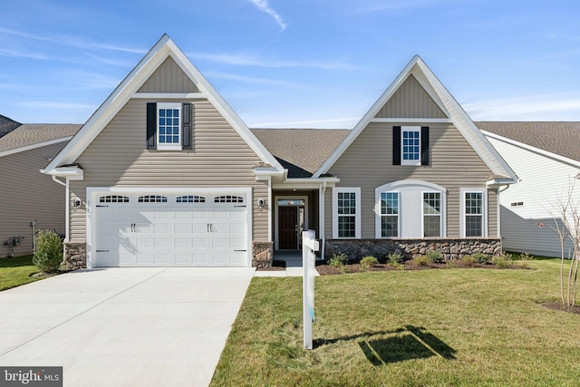 view of front of property featuring concrete driveway, board and batten siding, a garage, stone siding, and a front lawn