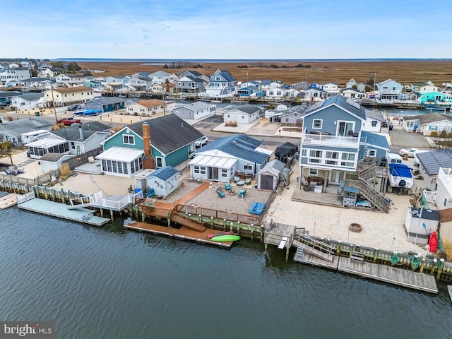 birds eye view of property featuring a water view and a residential view