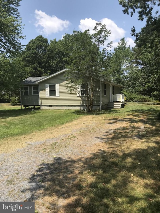 view of property exterior featuring crawl space and a lawn