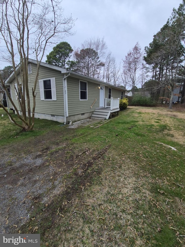 exterior space featuring crawl space and a yard