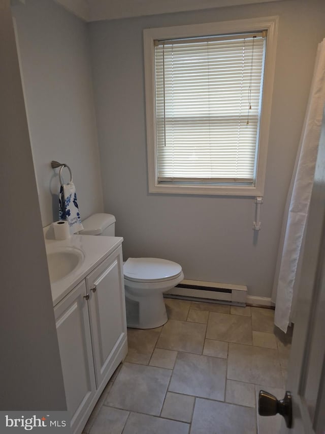 full bath with baseboards, toilet, a baseboard heating unit, and vanity