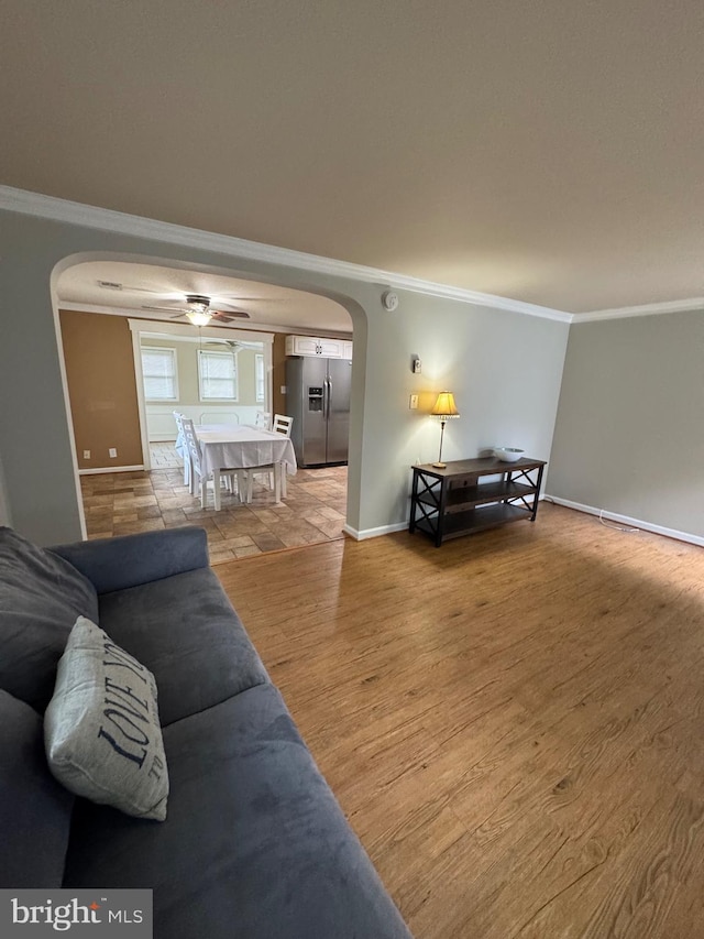 22 Alden Ct, Berlin, MD 21811 - living area featuring arched walkways, ornamental molding, baseboards, and light wood finished floors