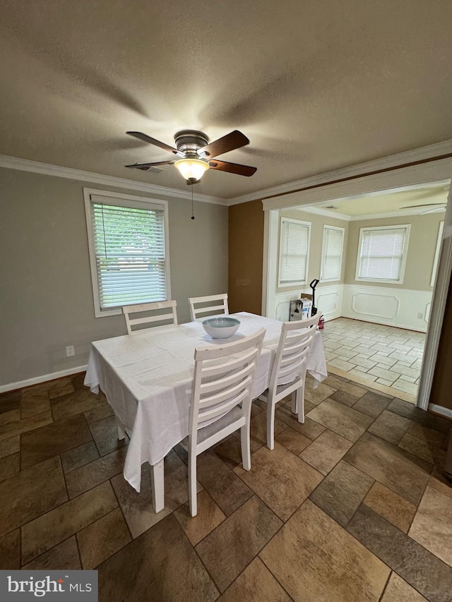 22 Alden Ct, Berlin, MD 21811 - dining space featuring crown molding, baseboards, a ceiling fan, stone tile flooring, and a textured ceiling