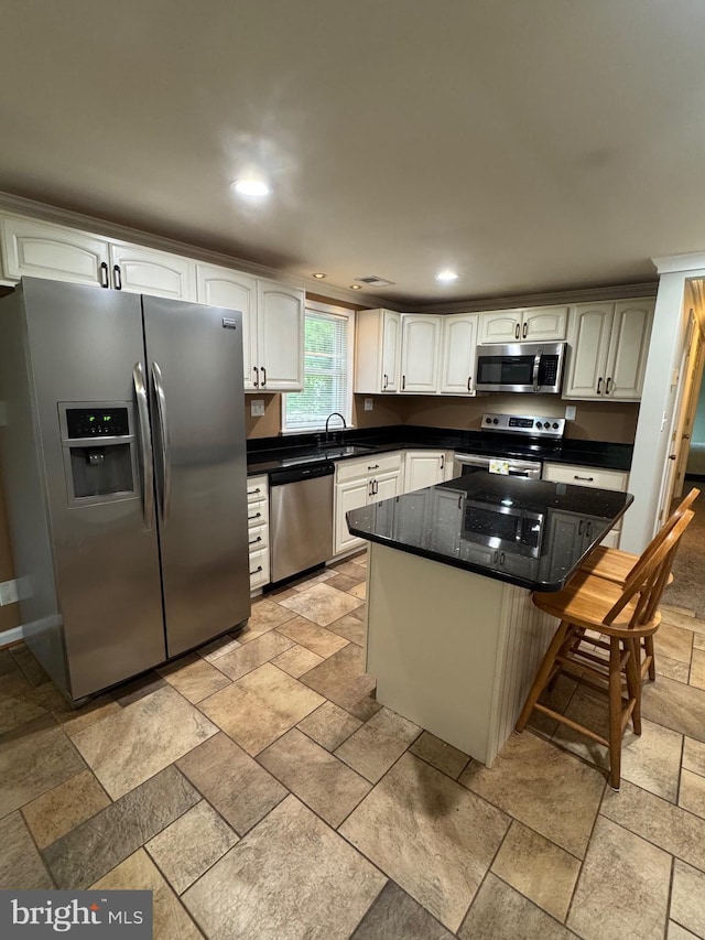 22 Alden Ct, Berlin, MD 21811 - kitchen with stainless steel appliances, a sink, a kitchen bar, stone tile floors, and recessed lighting