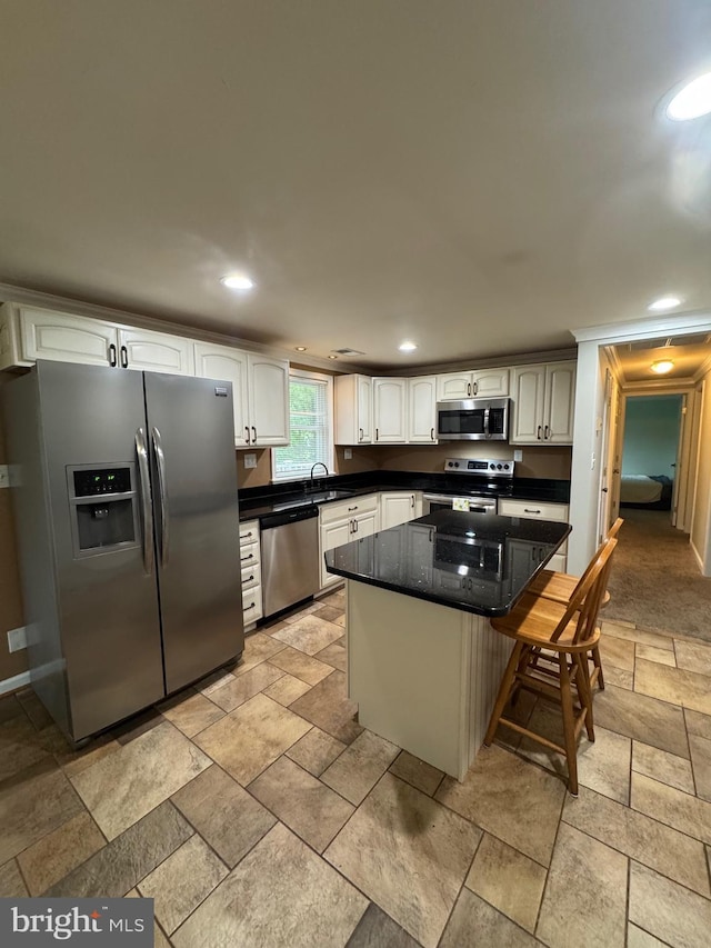 22 Alden Ct, Berlin, MD 21811 - kitchen featuring stainless steel appliances, a sink, stone tile flooring, a kitchen breakfast bar, and a center island