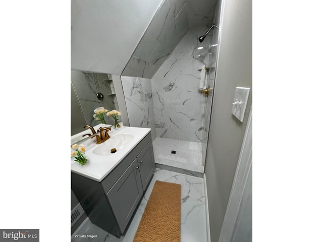 bathroom featuring vanity, marble finish floor, and a marble finish shower