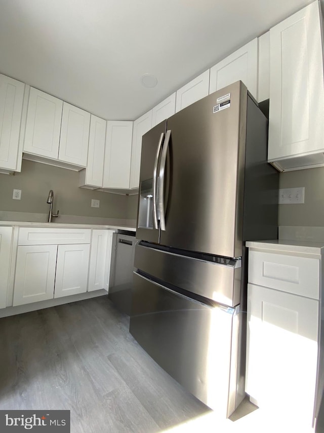 kitchen with white cabinets and stainless steel refrigerator with ice dispenser