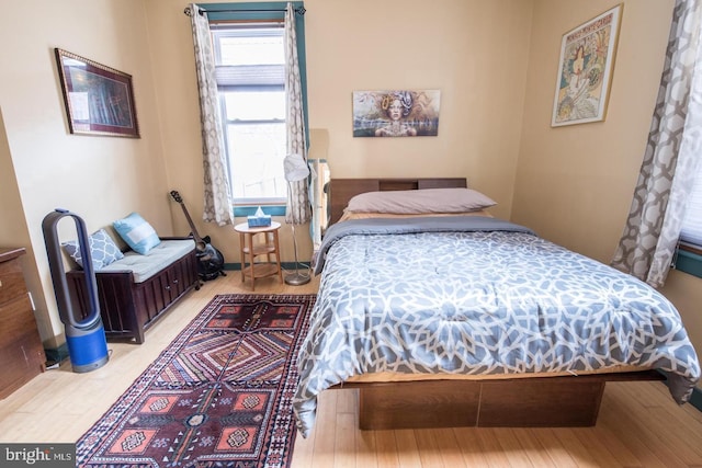 bedroom with baseboards and wood finished floors