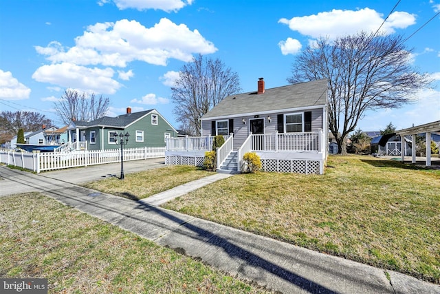 bungalow-style house with a front lawn, fence, a residential view, concrete driveway, and a deck