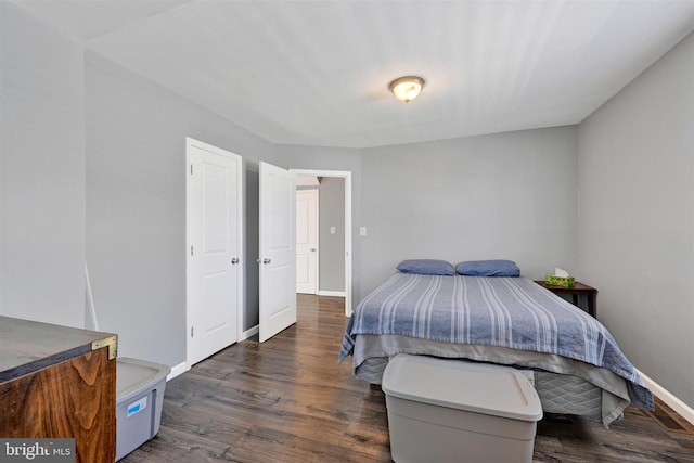 bedroom with wood finished floors and baseboards