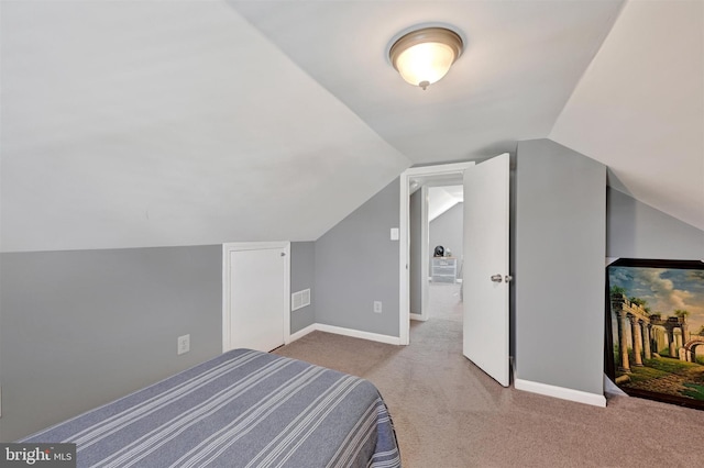 bedroom with vaulted ceiling, carpet, and baseboards