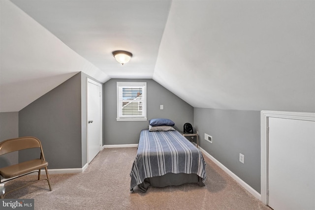 bedroom featuring vaulted ceiling, carpet, and baseboards