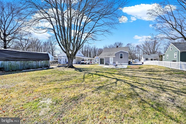 view of yard featuring a patio area, a residential view, and fence