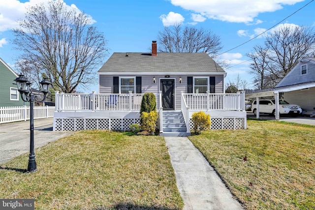 bungalow with a chimney, a deck, a front lawn, and fence