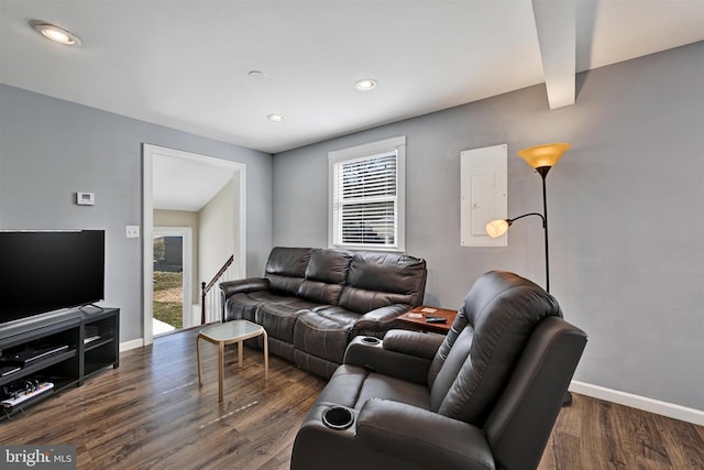 living area featuring dark wood finished floors, recessed lighting, electric panel, and baseboards