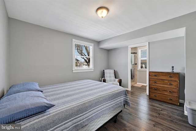 bedroom with wood finished floors and baseboards