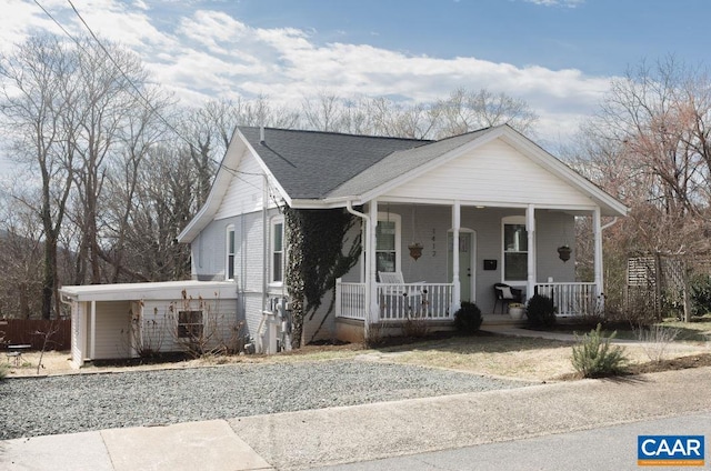 bungalow-style house featuring a porch and roof with shingles