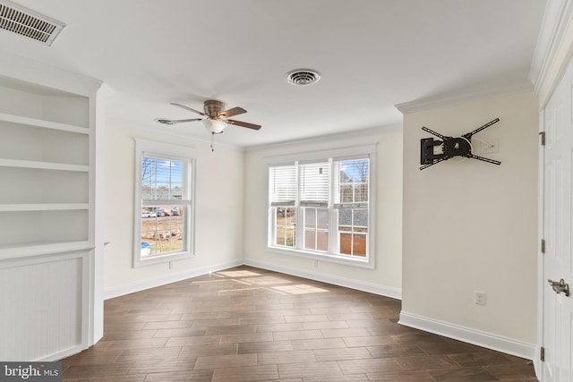 unfurnished dining area featuring ornamental molding, dark wood-style flooring, visible vents, and baseboards