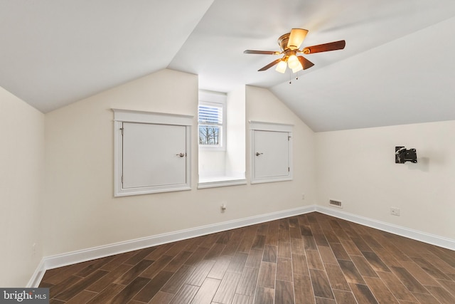 bonus room featuring visible vents, baseboards, a ceiling fan, wood finished floors, and vaulted ceiling