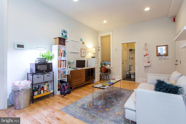 living room with baseboards, light wood-style flooring, and recessed lighting