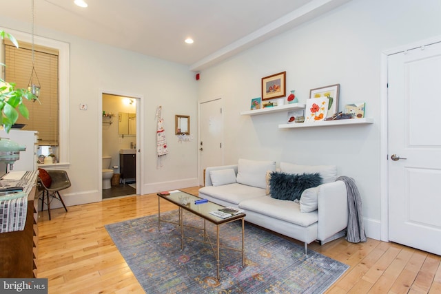 living room with baseboards, hardwood / wood-style floors, and recessed lighting