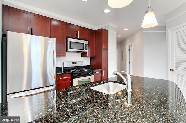 kitchen with pendant lighting, a sink, recessed lighting, appliances with stainless steel finishes, and dark brown cabinets