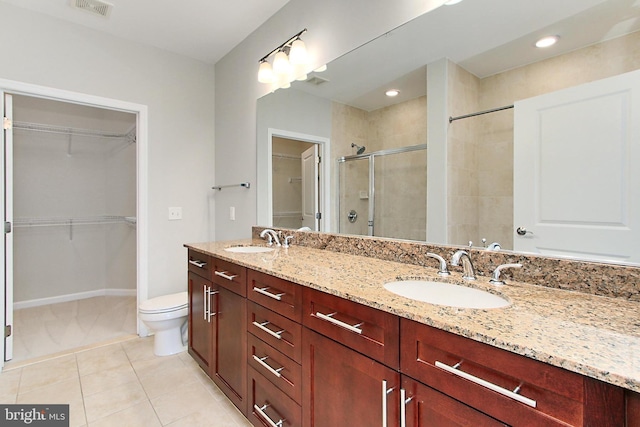 bathroom featuring a sink, visible vents, a stall shower, and tile patterned floors