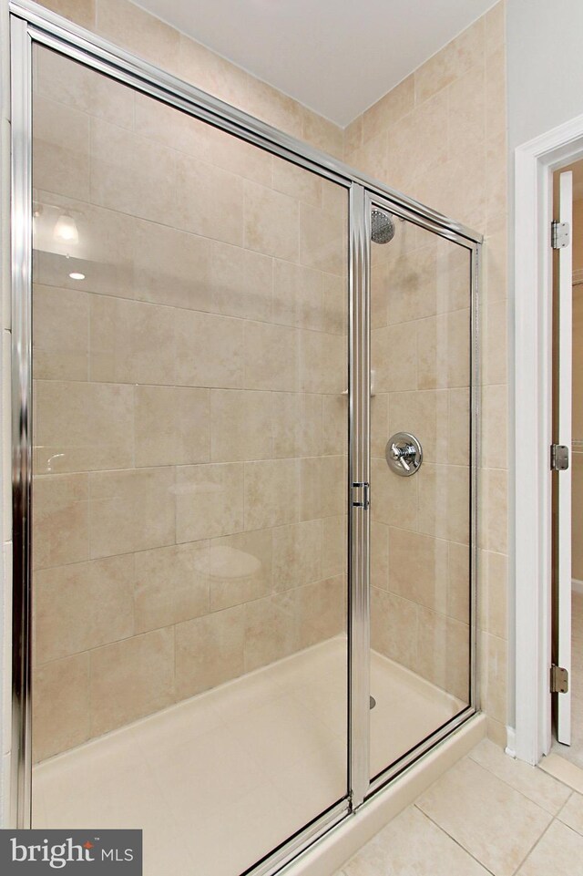 full bath featuring a shower stall and tile patterned floors