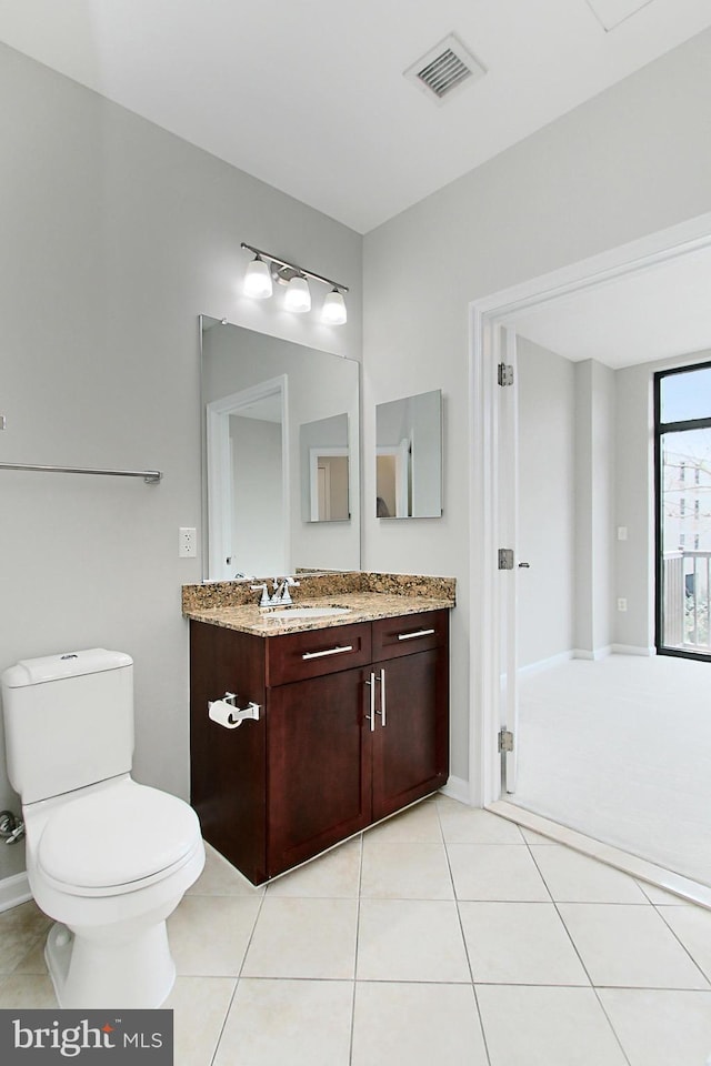 bathroom featuring visible vents, toilet, vanity, and tile patterned flooring