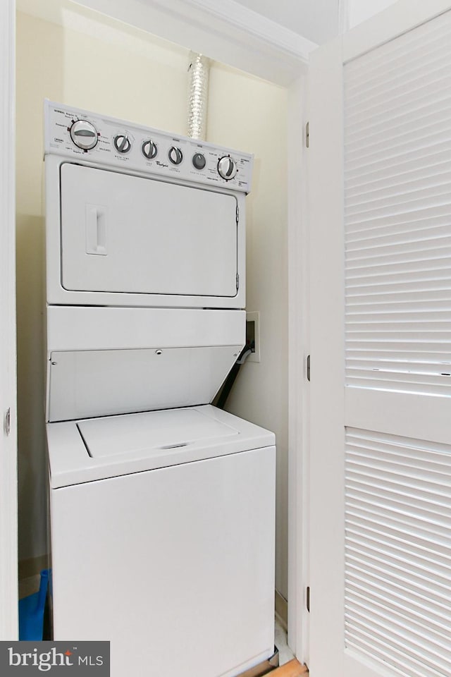 clothes washing area featuring laundry area and stacked washer / dryer