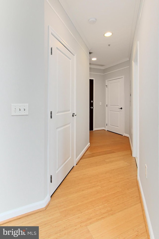 hall with recessed lighting, light wood-style flooring, and baseboards