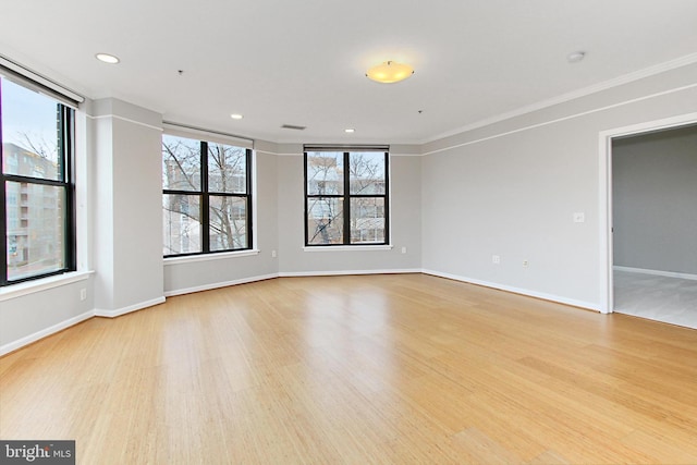 unfurnished room with recessed lighting, baseboards, crown molding, and light wood finished floors