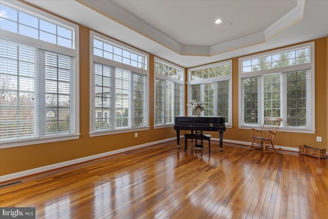 sunroom featuring a raised ceiling and visible vents