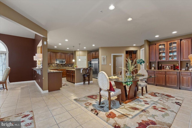 dining area featuring recessed lighting, light tile patterned flooring, and baseboards