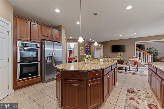 kitchen with hanging light fixtures, light tile patterned floors, stainless steel appliances, and recessed lighting