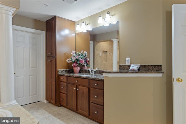 bathroom featuring decorative columns, tile patterned flooring, and vanity