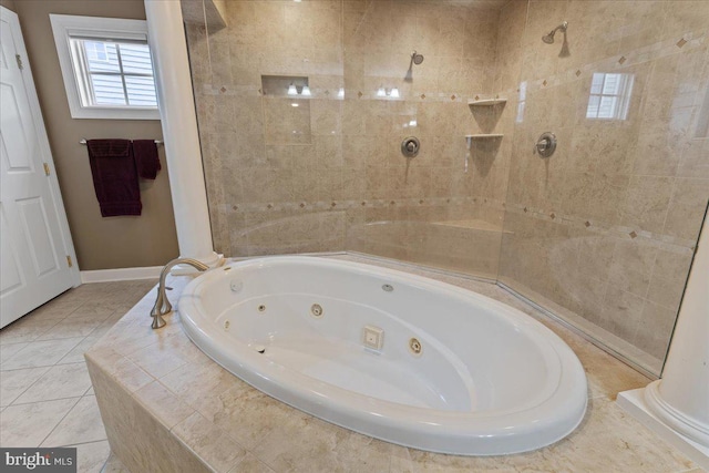 bathroom with baseboards, a tub with jets, tiled shower, and tile patterned floors