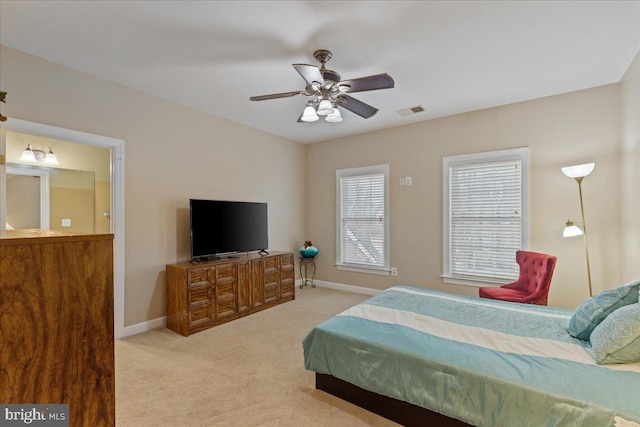 bedroom with a ceiling fan, baseboards, visible vents, and carpet flooring