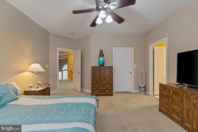 bedroom with light carpet, a ceiling fan, and baseboards