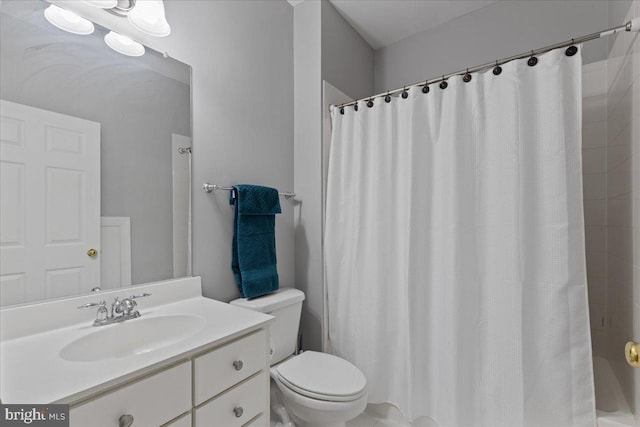 bathroom featuring toilet and vanity