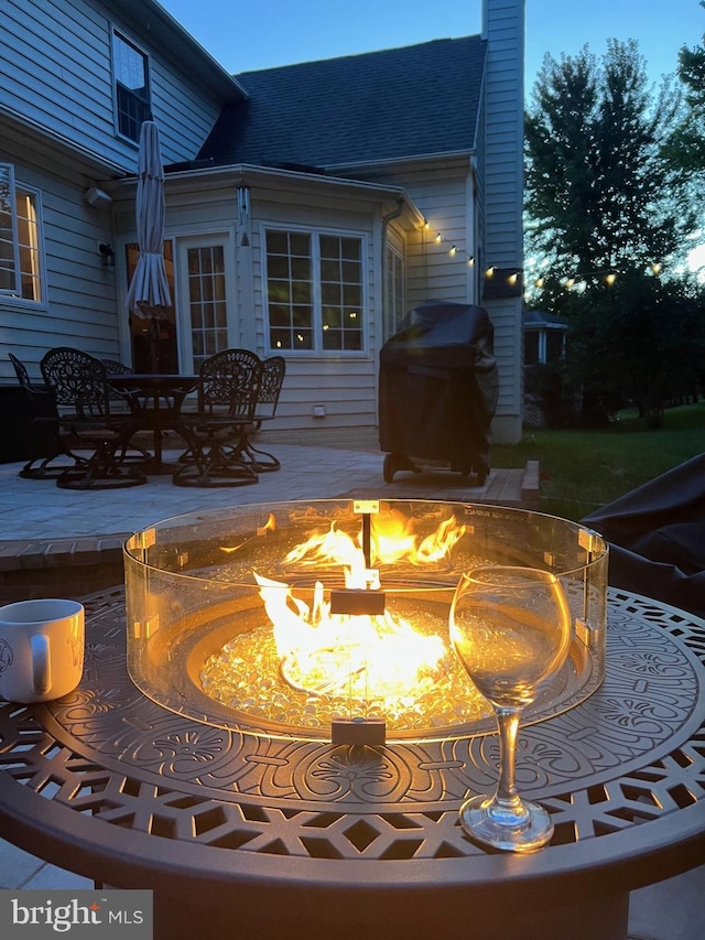 exterior space featuring a fire pit, a patio, and grilling area