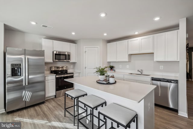 kitchen with white cabinetry, visible vents, appliances with stainless steel finishes, and a sink