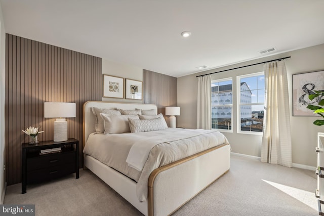 bedroom featuring light colored carpet, visible vents, and baseboards