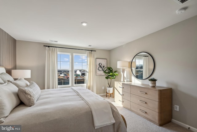 bedroom featuring light colored carpet, visible vents, and baseboards