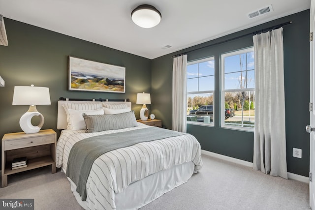 bedroom featuring light colored carpet, visible vents, and baseboards