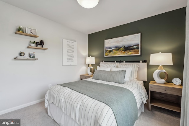 carpeted bedroom featuring baseboards