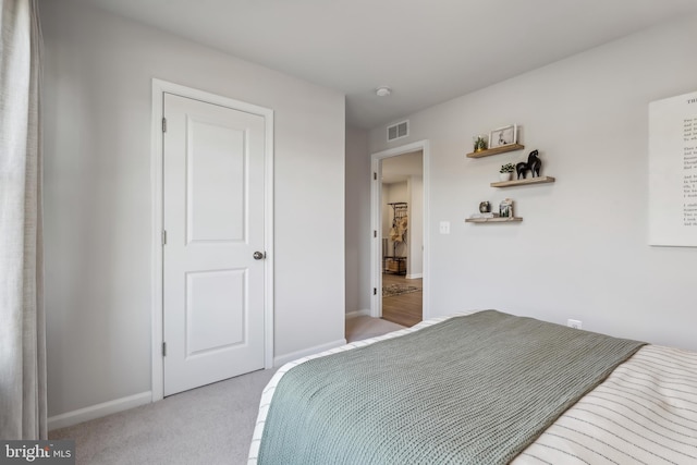 bedroom featuring light colored carpet, visible vents, and baseboards