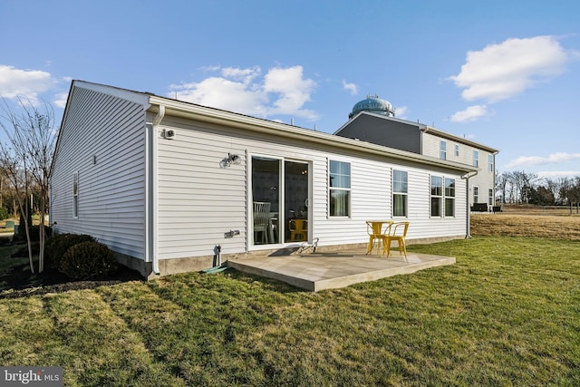 back of property featuring a yard and a patio