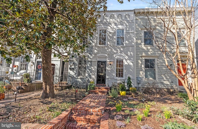 view of front of home featuring fence