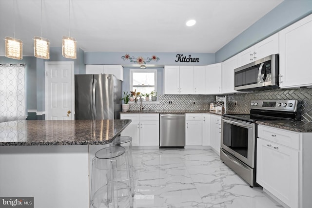 kitchen featuring decorative backsplash, marble finish floor, white cabinetry, and stainless steel appliances